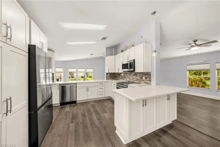 Modern kitchen with white cabinetry and stainless steel appliances