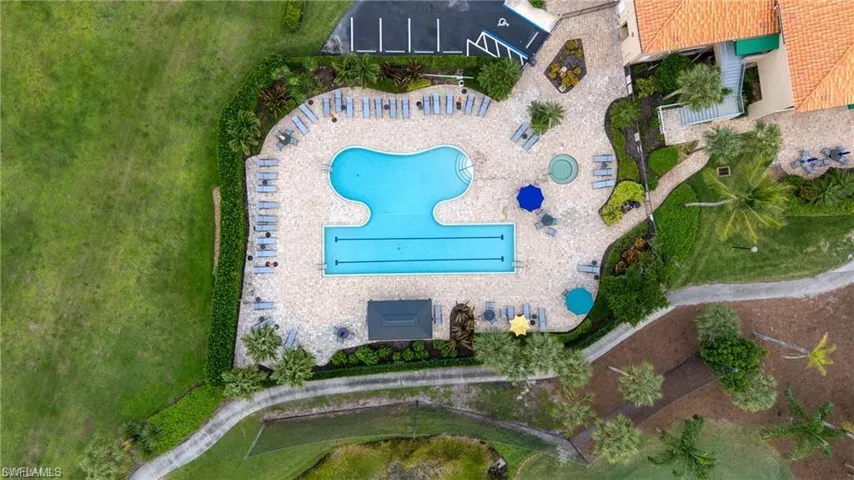 Outdoor recreation area featuring a multi-lane lap pool, a freeform pool, and a circular spa