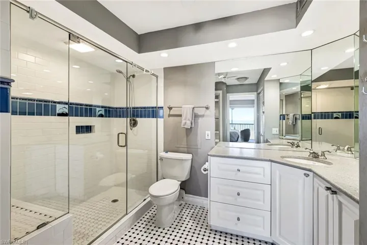 Ensuite bathroom featuring vanity, a stall shower, recessed lighting, and light tile patterned flooring