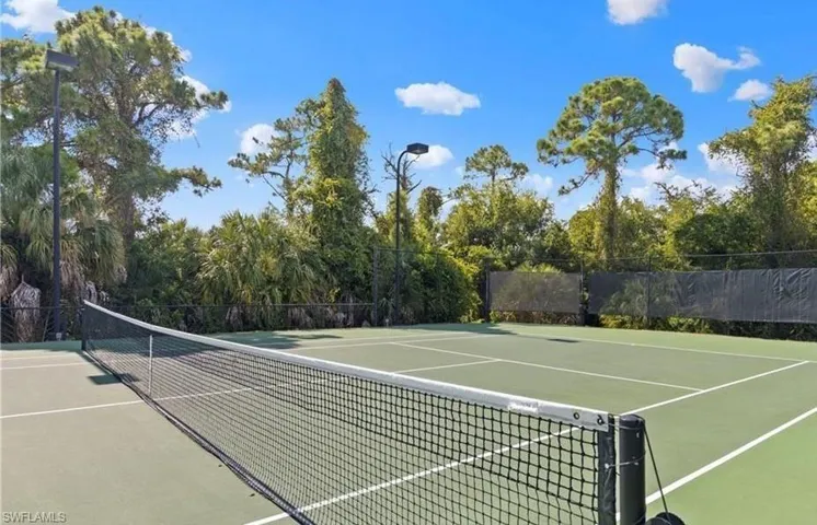 View of tennis court with community basketball court