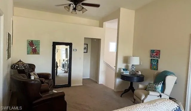 Sitting room with carpet flooring and a ceiling fan