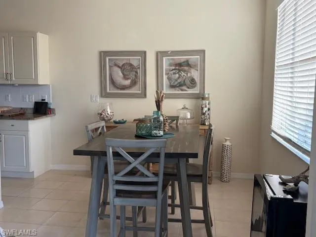 Dining room featuring plenty of natural light and light tile patterned flooring