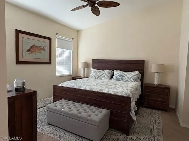 Bedroom with a ceiling fan and baseboards