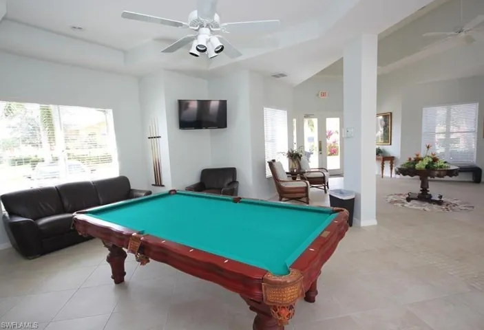 Playroom with a ceiling fan, billiards, and french doors