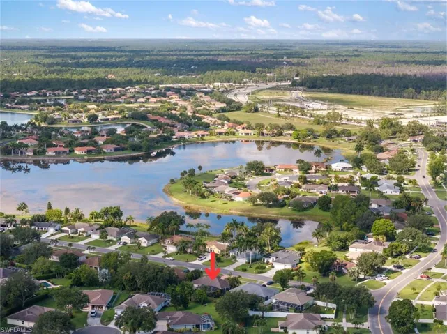 Birds eye view of property with a water view