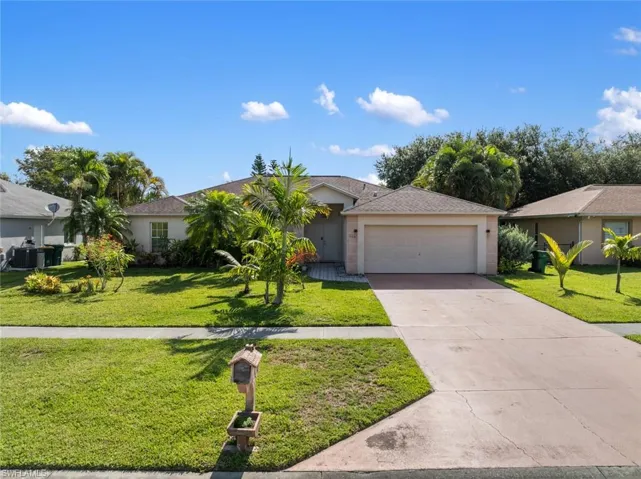 Single story home with a garage, central AC, and a front lawn