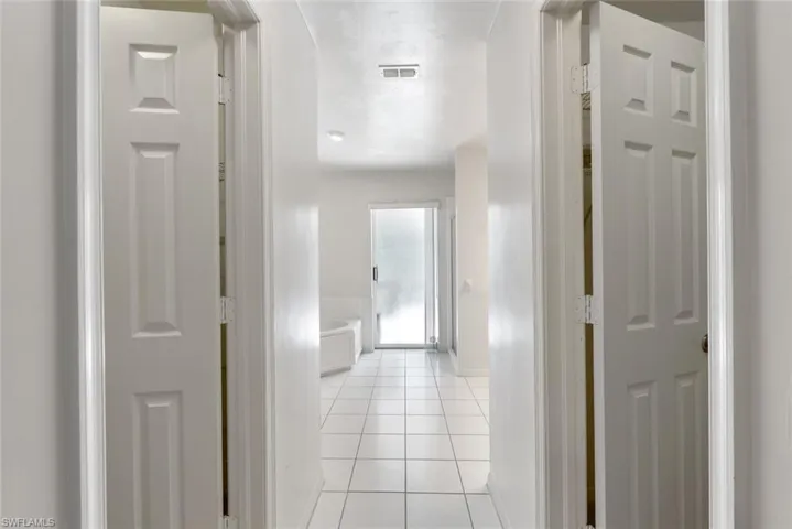 Hall featuring light tile floors