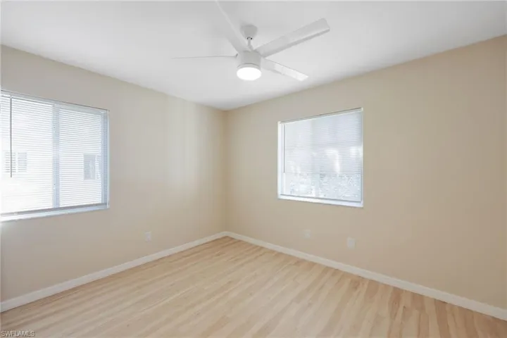 Unfurnished room with ceiling fan and light wood-style floors