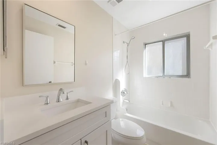 Full bath with vanity and shower / bath combination