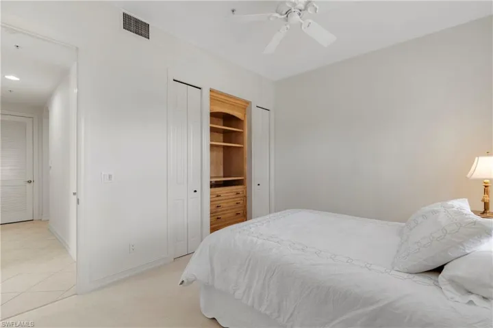 Carpeted bedroom featuring ceiling fan