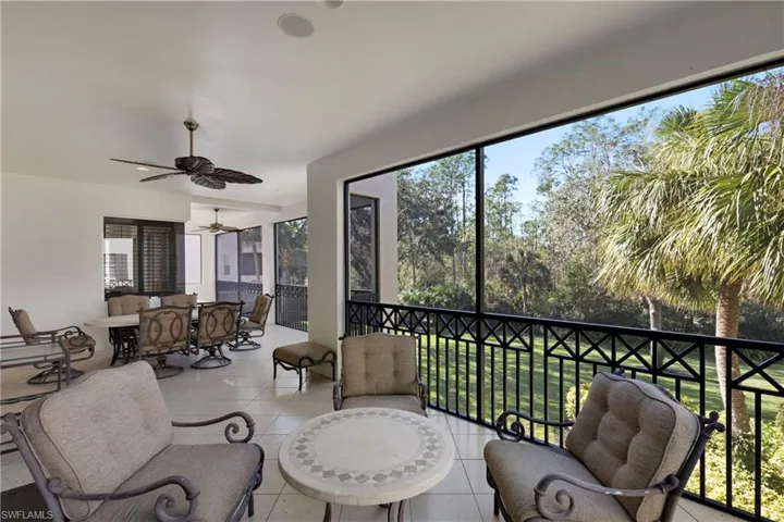Sunroom featuring ceiling fan and plenty of natural light