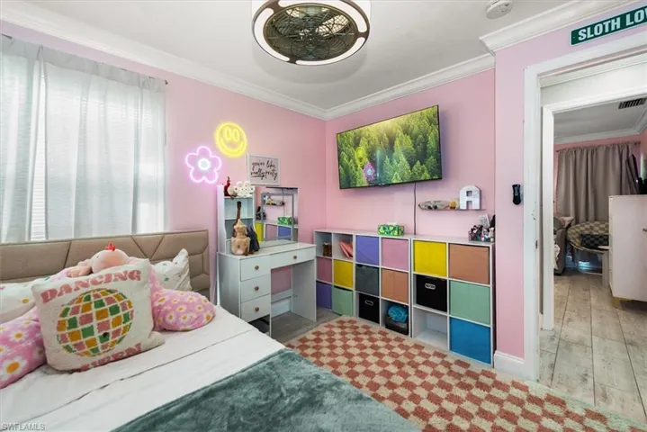 Bedroom with ornamental molding and light wood-type flooring