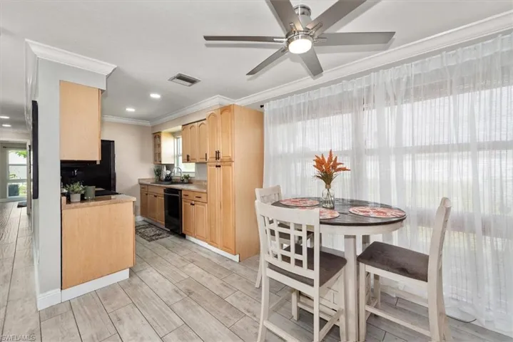 Kitchen with ornamental molding, light countertops, light brown cabinetry, light wood finished floors, and recessed lighting