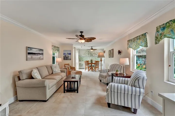 Spacious living area with tile floors and lots of windows