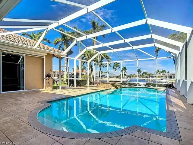 View of swimming pool with a lanai and a patio area