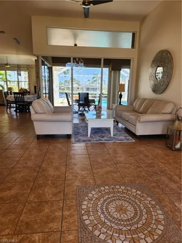 Living area featuring a notable chandelier and a healthy amount of sunlight