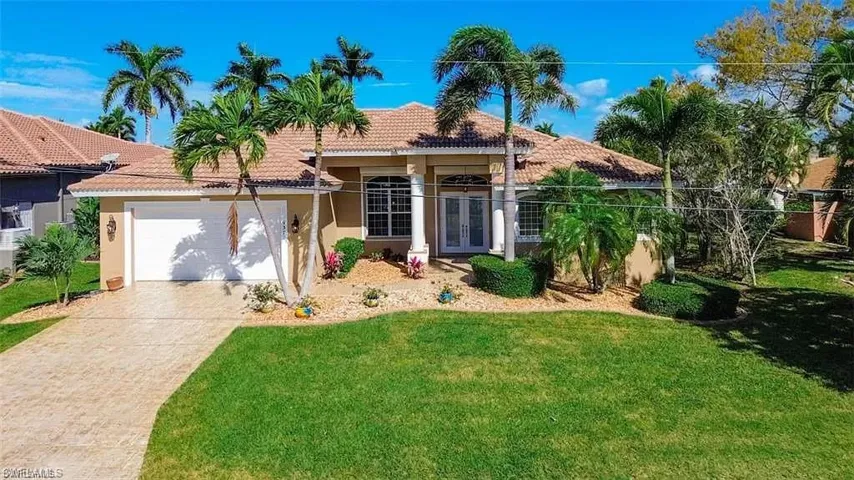 Mediterranean / spanish-style home with a garage and a front yard