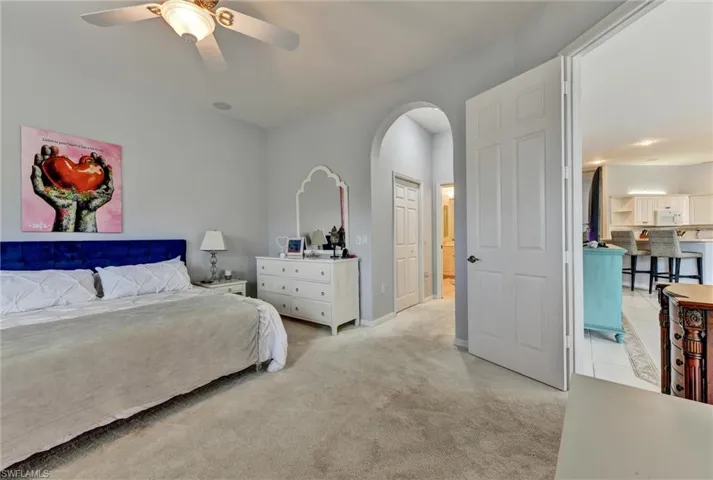 Bedroom with light carpet and ceiling fan