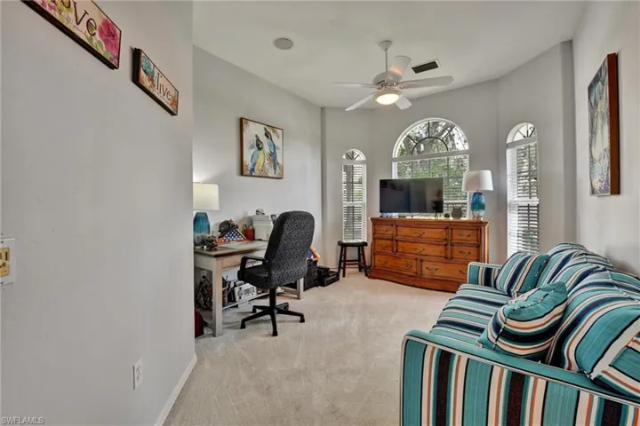 Carpeted office space with ceiling fan
