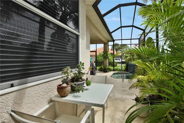 View of patio featuring a lanai