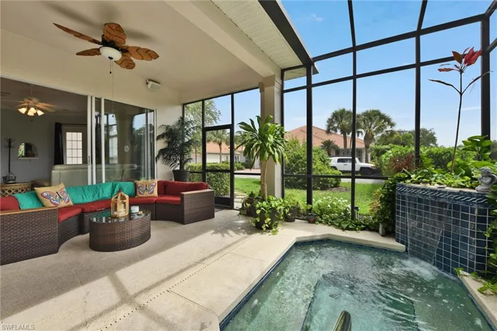 View of spa with an outdoor hangout area, a lanai, ceiling fan, and a jacuzzi