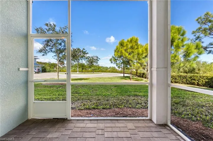 Screened back patio with private view of landscaped area.