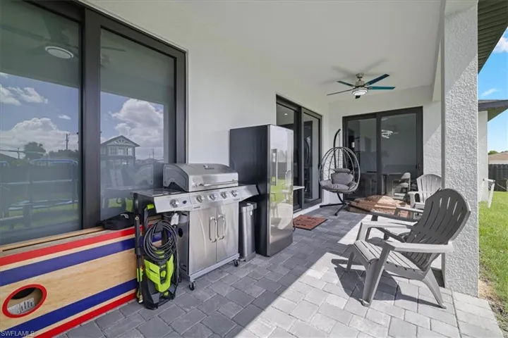View of patio featuring a ceiling fan and a grill