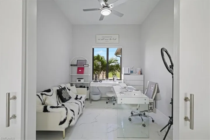 Office space with marble look tile flooring and ceiling fan