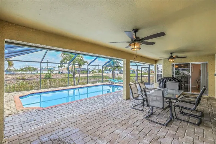 Screened-in lanai featuring a paver patio and inground pool