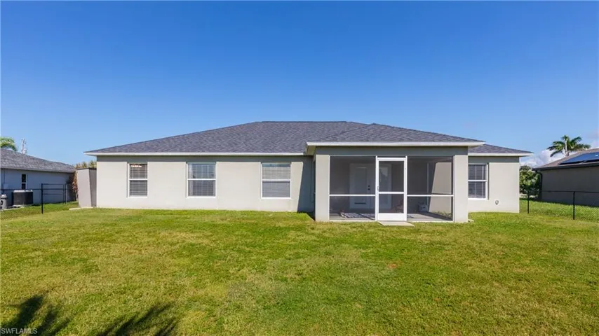 Rear view of property featuring stucco siding and a sunroom