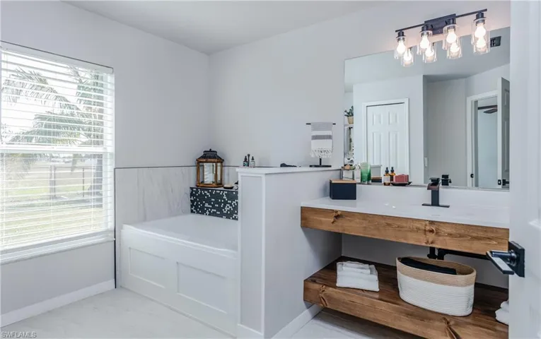 Bathroom featuring vanity and a bath