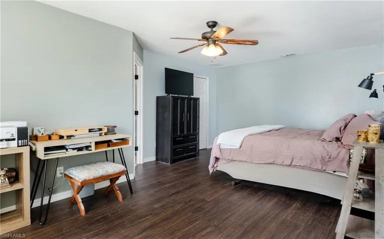 Bedroom featuring dark wood finished floors and ceiling fan