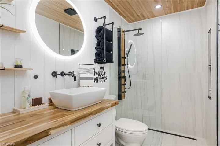 Bathroom with wooden ceiling, vanity, a stall shower, and recessed lighting