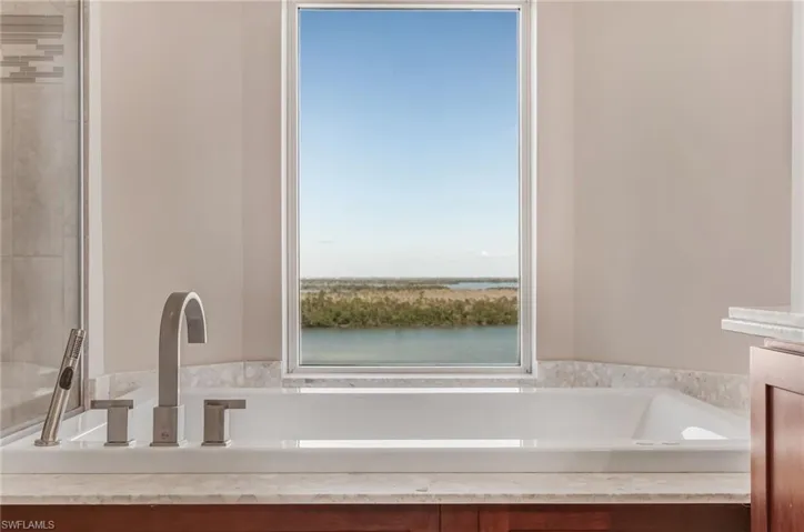 Bathroom with a garden tub and vanity and beautiful view of the Bay