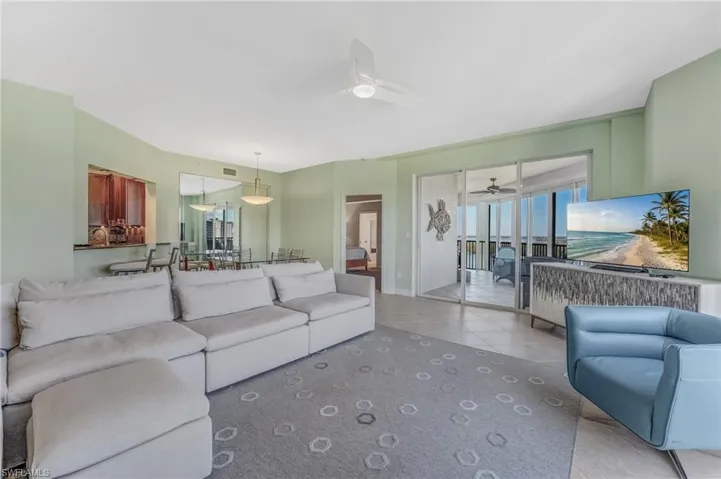 Living room with light tile floors and ceiling fan