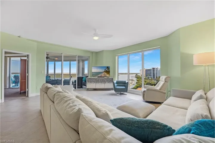 Living area featuring ceiling fan and tile with Bay views