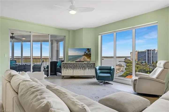 Tiled living room featuring ceiling fan with Bay views