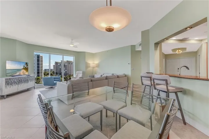 Dining space featuring light tile flooring and ceiling fan