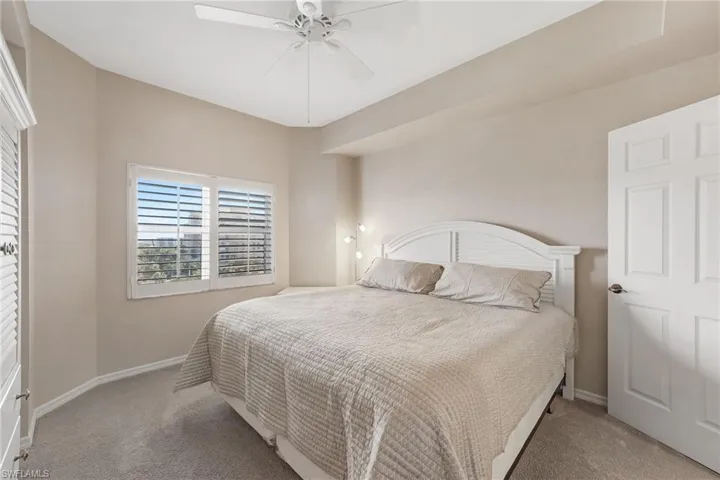 Guest bedroom featuring a ceiling fan and baseboards
