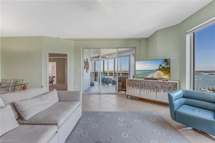 Tiled living room featuring ceiling fan