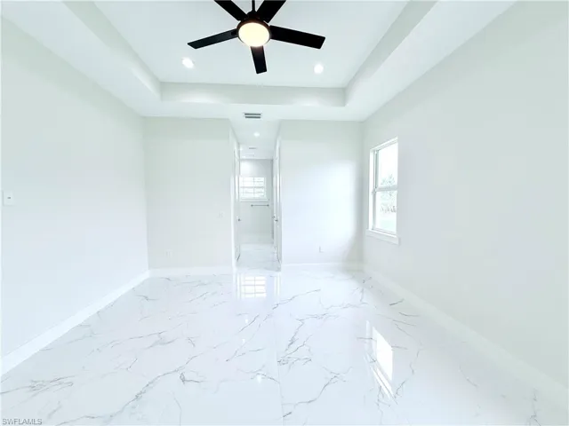 Spare room featuring a ceiling fan, recessed lighting, baseboards, and light marble finish floors