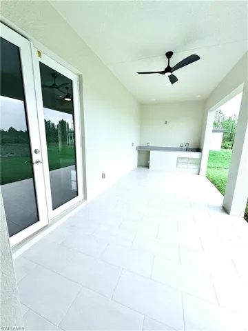 View of patio / terrace with french doors and ceiling fan