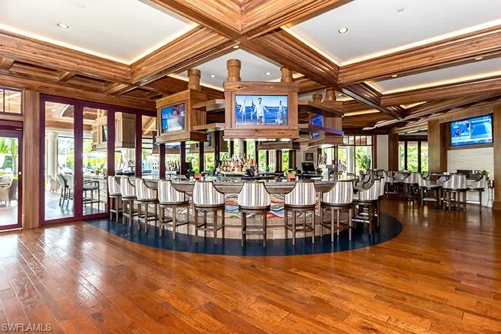 Dining room with coffered ceiling, beam ceiling, dark wood finished floors, and ornamental molding
