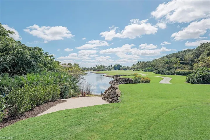 Water view featuring a local golf course and a tree filled landscape