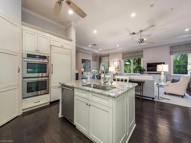 Kitchen featuring ceiling fan, recessed lighting, light stone countertops, crown molding, and stainless steel appliances