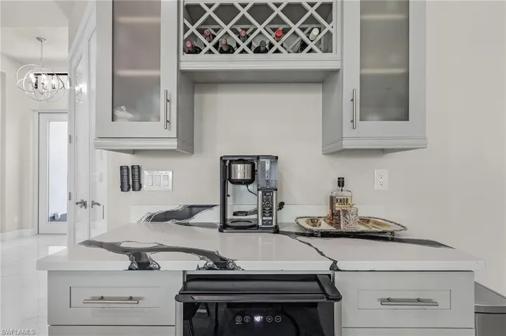 Kitchen featuring stove and an inviting chandelier