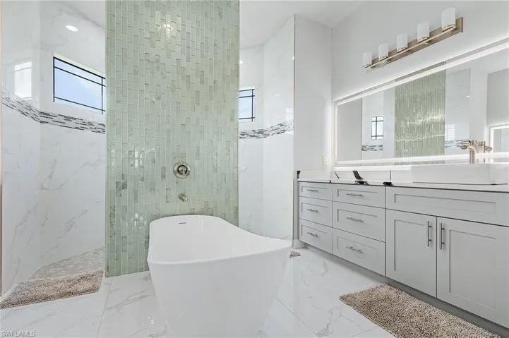 Bathroom with vanity and plus walk in shower