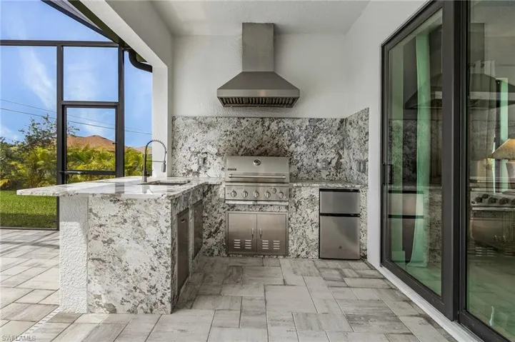 View of patio / terrace featuring area for grilling and sink
