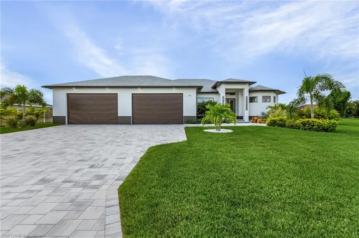 View of front of home featuring a garage and a front lawn
