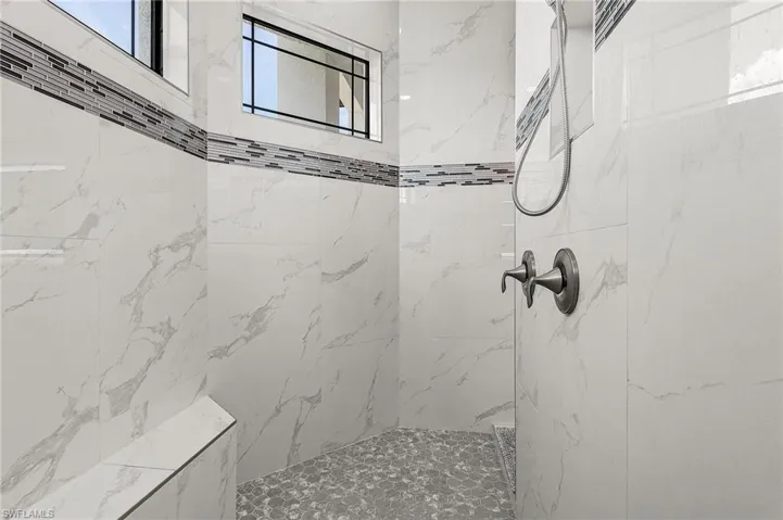 Bathroom featuring a tile shower
